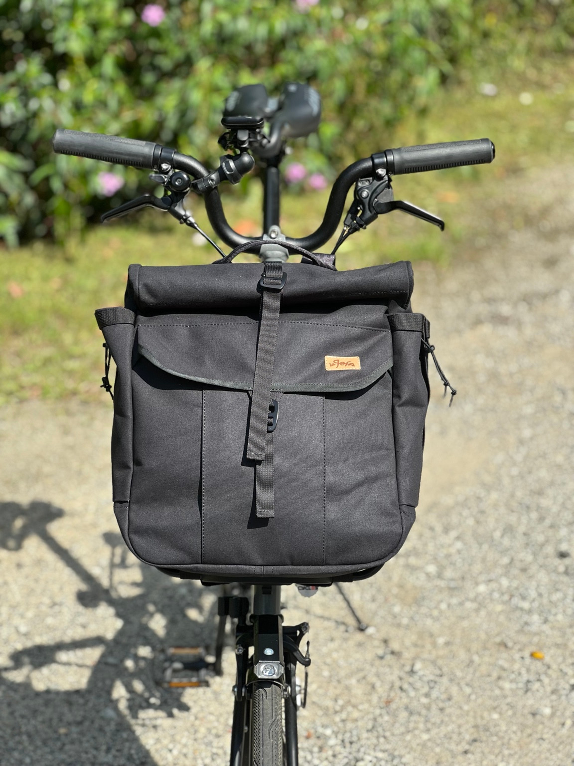 Front view of the black Bropack mounted on a Brompton bicycle
