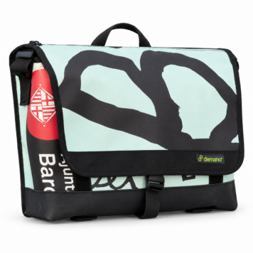 Demano Arago 1713 mint Brompton medium front bag with a large charcoal looping brush motif, black trim and sewn Demano label, isolated on white.