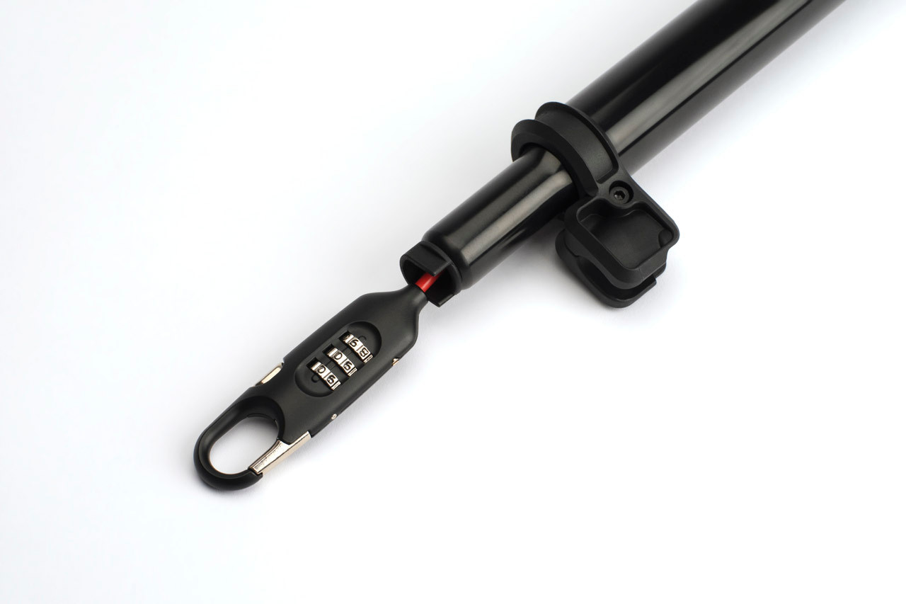 Close-up of the Brompton Cafe Lock combination mechanism and cable housing at the end of the extended seatpost.