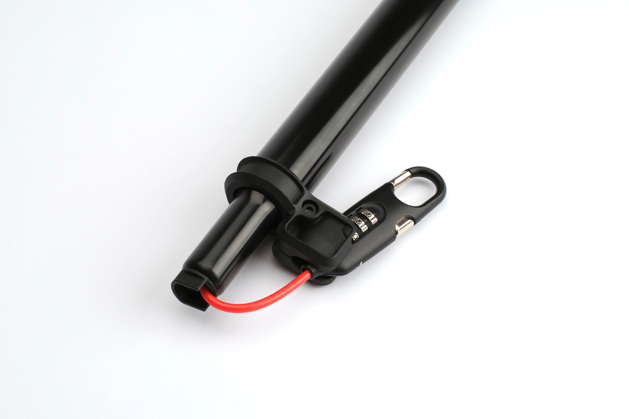 Brompton Cafe Lock clipped beside the black seatpost with its bright red cable stowed.