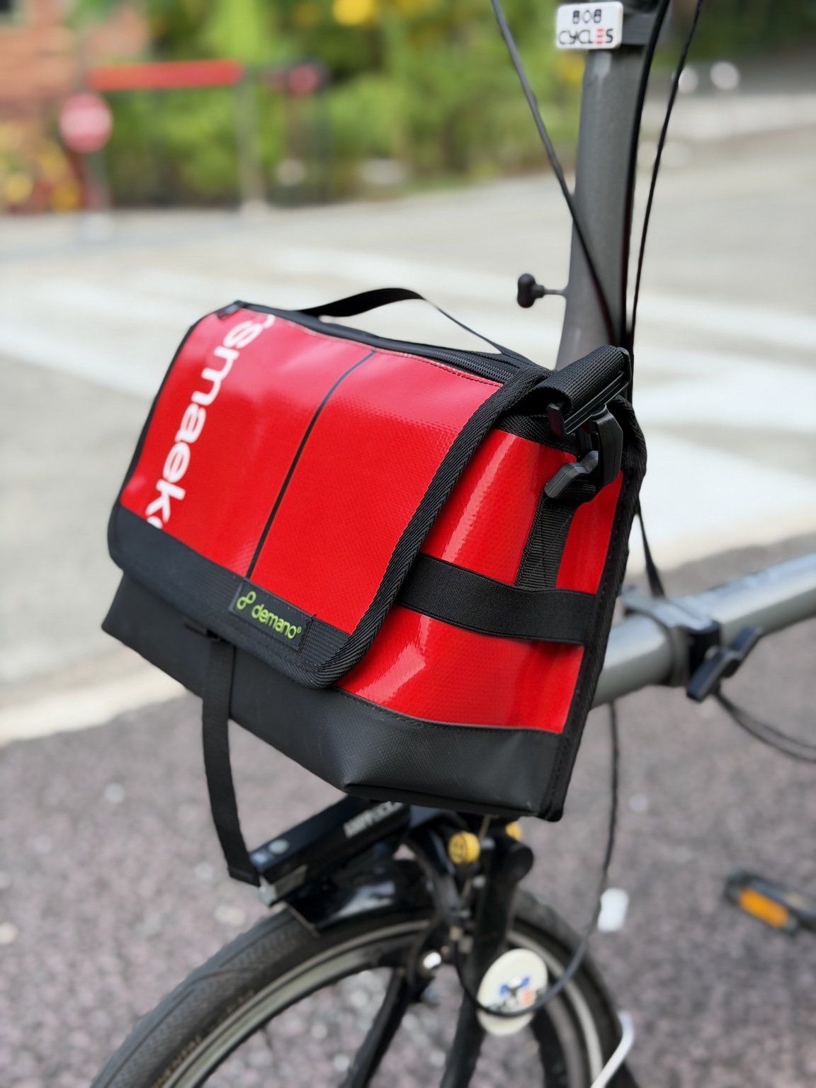 Right front angle showing the red PVC banner print and black trim of Demano Ribera 1701