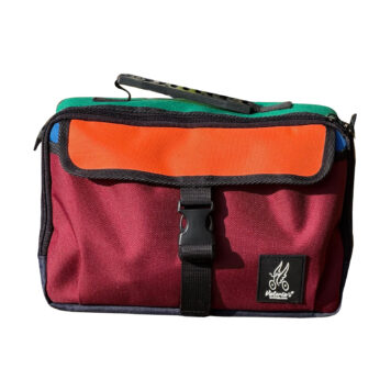 Valeria’s Barcelona Cris Mini #05 colour-block Brompton bag, burgundy front and orange flap on a white background