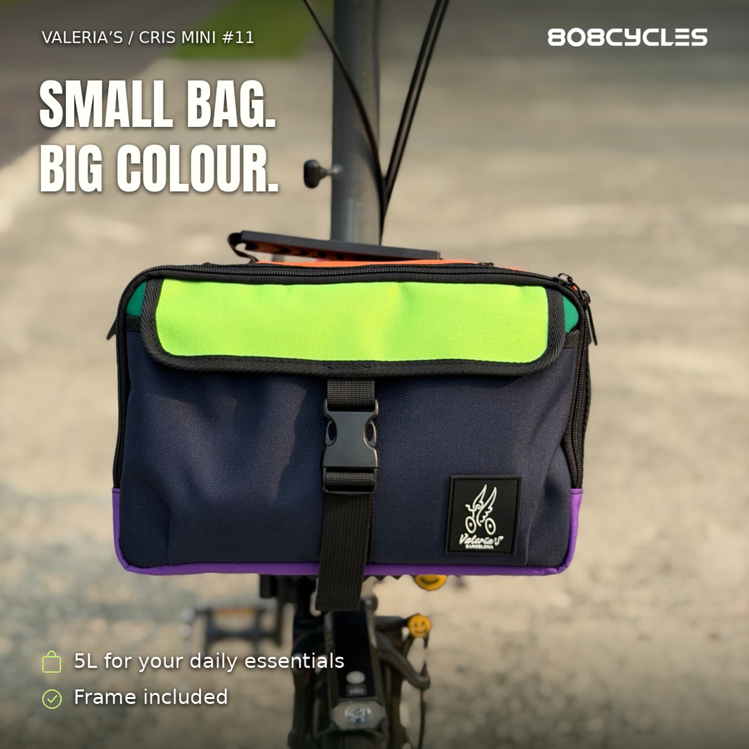 Feature graphic: Front view of Valeria’s Cris Mini #11 with navy front, lime flap and purple base mounted on a Brompton