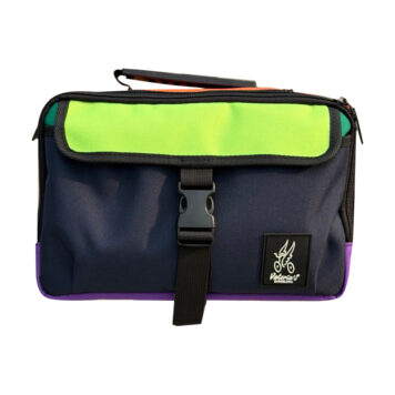 Valeria’s Cris Mini #11 colour-block Brompton bag with navy front and lime flap, isolated on white